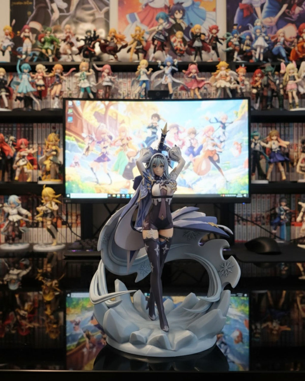 Anime figurine on a stand with a screen displaying animated characters in the background